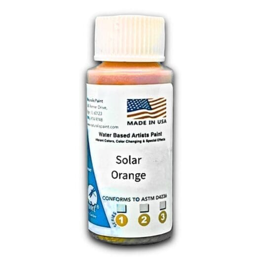 Bottle of Solar Orange water-based artist paint, featuring a U.S. flag and text that includes "Made in USA" and "Conforms to ASTM D4236.